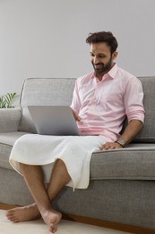 Man working from home and attending an office meeting on video call