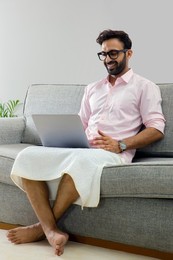 Man working from home and attending an office meeting on video call