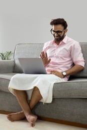 Man working from home and attending an office meeting on video call