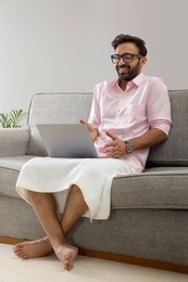 Man working from home and attending an office meeting on video call