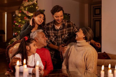 Happy family celebrating Christmas together in living room