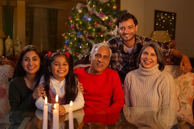 Happy family celebrating Christmas together in living room