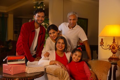 Happy family celebrating Christmas together in living room