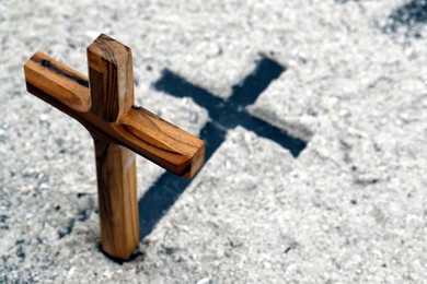 Ashes and wooden christian cross. Ash Wednesday celebration. Lent season.