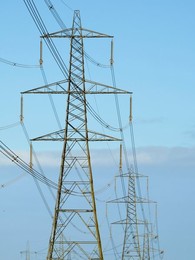 Giant pylon in a field in Sandford Village, winter sunrise