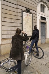 Reading of the musical program displayed on the facade of the Teatro alla Scala, Milan, Lombardy, Italy, Europe