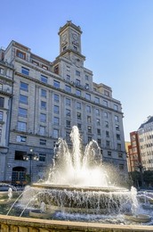 Oviedo, Spain, The Cajastur Bank Building and a water fountain in the Plaza de la Escandalera. The area is a local landmark and a popular travel destination.