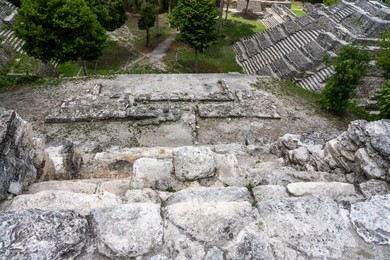 Structure 142, a temple pyramid in the North Acropolis in the Mayan ruins in Yaxha-Nakun-Naranjo National Park, Guatemala.  Note the throne near the top of the stairs.  Structure 144 is at right.