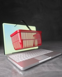Conceptual shopping basket extruding through a laptop computer screen for online shopping 3d render