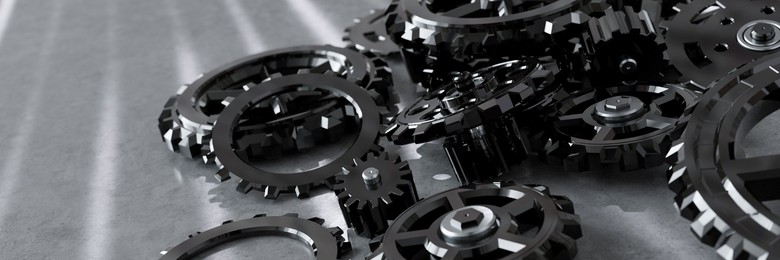 Pile of assorted metal gears and cogs on a table 3d render