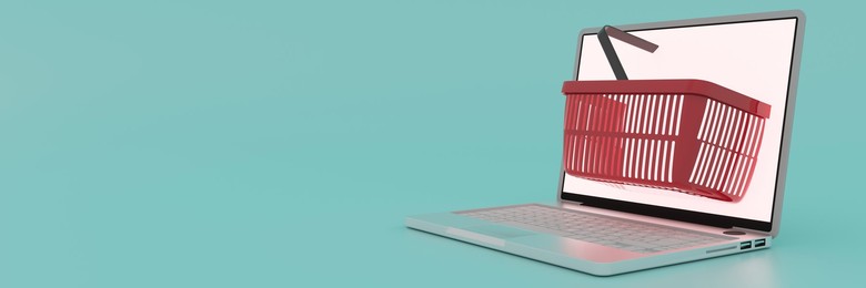 Conceptual shopping basket extruding through a laptop computer screen for online shopping 3d render