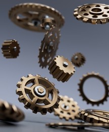 Assorted bronze and metal gears and cogs falling apart onto a table concept 3d render