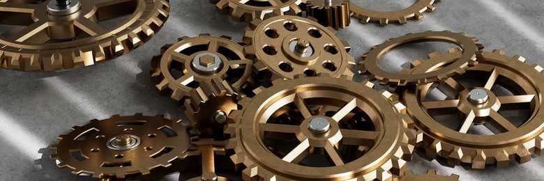 Pile of assorted metal gears and cogs on a table 3d render