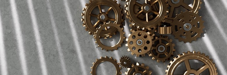 Pile of assorted metal gears and cogs on a table 3d render