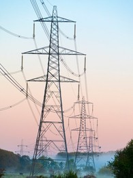 Giant pylon in a field in Sandford Village, winter sunrise