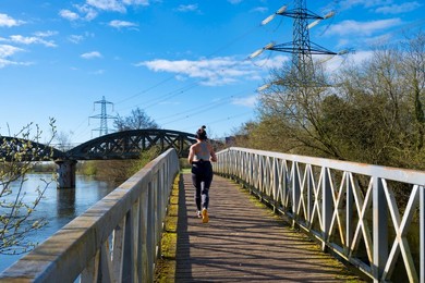 Early jogger - bridges and pylons at the confluence of the River Thames and Hinksey Stream at Kennington