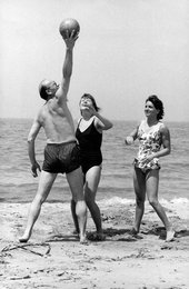 The Beneck family playing with a ball on the beach