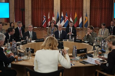 Britain's Prime Minister Keir Starmer, center left, joins leaders for a round ta