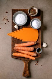 Korean and Asian Cuisine. Ingredients For Preparing Vegetable Salad of the rinated Carrots. Raw Carrots. Seasonings. Grater on Wooden Cutting Board. Mocha Mousse Background. Healthy Cooking. Top View