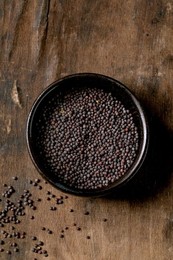 Black Mustard Seeds For Cooking Dijon Mustard In Black Ceramic Bowl On Dark Wooden Table. Healthy Eating. Spicy Cooking Ingredients. Traditional Kitchen. Top View