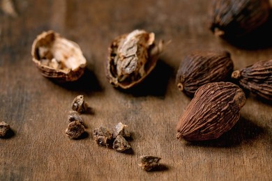 Black Cardamom Whole and Seeds On Dark Wooden Table. Healthy Eating. Spicy Cooking Ingredients. Asian Kitchen