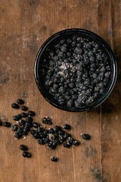 Black Salted Fermenter Campota Pepper In Black Ceramic Bowl On Dark Wooden Table. Healthy Eating. Spicy Cooking Ingredients. Asian Kitchen. Top View