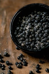 Black Salted Fermenter Campota Pepper In Black Ceramic Bowl On Dark Wooden Table. Healthy Eating. Spicy Cooking Ingredients. Asian Kitchen. Close Up