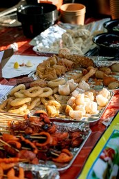 Street Food Festival In Europe. Asian Street Food. Grilled Seafood Skewers On Counter. Fast Food Dish from Street Vendor. Shrimp. Squid. Octopus Ready To Eat.