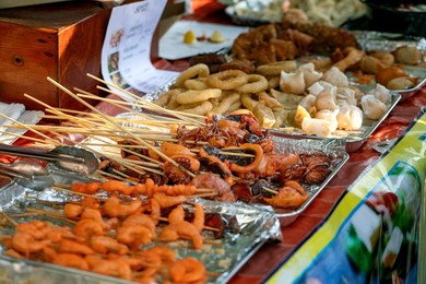 Street Food Festival In Europe. Asian Street Food. Grilled Seafood Skewers On Counter. Fast Food Dish from Street Vendor. Shrimp. Squid. Octopus Ready To Eat.