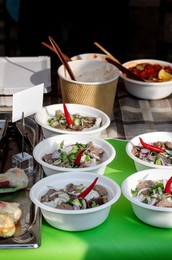Street Food Festival In Europe. Traditional Vietnamese Pho-bo In Disposable Bowls On Counter. Fast Food Dish from Street Vendor. Hot and Aromatic. Ready To Eat.
