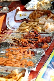 Street Food Festival In Europe. Asian Street Food. Grilled Seafood Skewers On Counter. Fast Food Dish from Street Vendor. Shrimp. Squid. Octopus Ready To Eat.