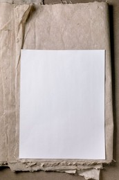 Clean White Blank Ricae And Mulberry Paper Sheet Placed on Textured Beige Craft Paper Background Minimalist Composition Perfect For Mockup Designs