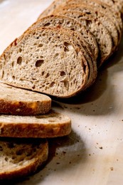 Freshly Baked Whole Grain Bread Sliced on Light Background. Artisanal Bread with Porous Texture Crispy Crust. Organic Healthy Baking