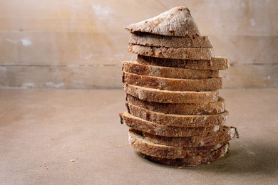 Stack of Sliced Rye Bread with Crunchy Crust on Beige Background. Homemade Artisan Bread Perfect For Sandwiches Breakfast or Healthy Eating