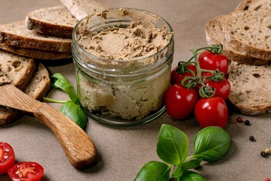 Homemade Liver Pate In Glass Jar with Bread Slices Cherry Tomatoes Fresh Basil Leaves And Wooden Spoon. Healthy Appetizer For Breakfast or Snack