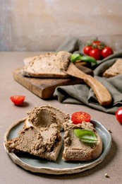Delicious Homemade Pate Spread on Bread Slices with Fresh Cherry Tomatoes Basil Garnish. Rustic Wooden Board Ceramic Plate Linen Napkin. Healthy Appetizer
