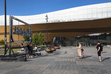 Tourist Taking A Selfie in Front of the Helsinki Sign