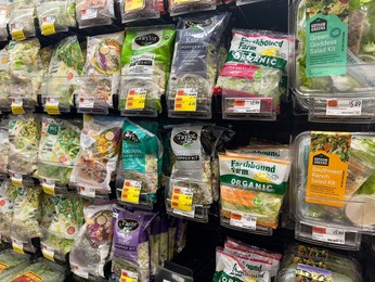 Assortment of pre-packaged organic lettuce on store shelves, Whole Foods Market, New York City, New York, USA
