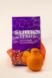 A package of Sumo citrus mandarins on a white background