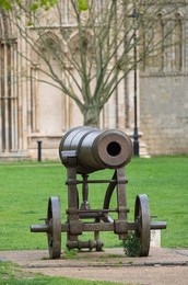Captured Russian cannon , dating from Victorian times outside  Ely Cathedral ,  Ely, Cambridgeshire, UK.
