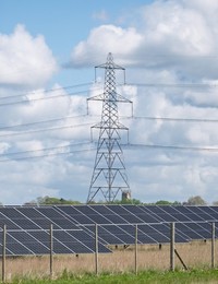 Solar power station and National grid power lines between Soham and wicken, near Ely, cambridgeshire, UK.