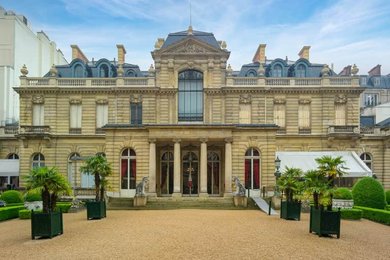 Musée Jacquemart-André mansion facade with gravel courtyard and palms, Paris, France
